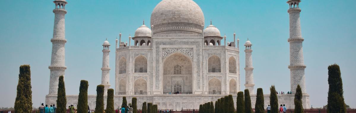 Taj Mahal and reflective fountain in front on a clear day. 